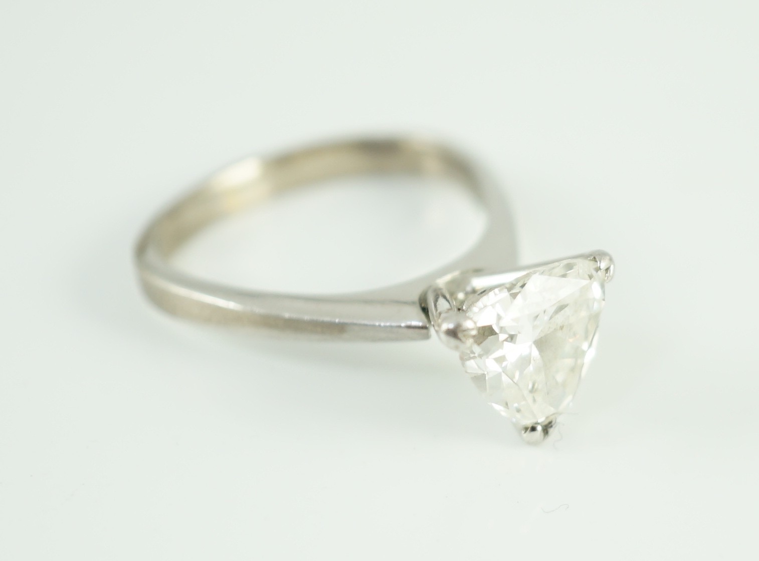 A modern platinum and solitaire trillion cut diamond set ring